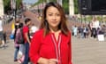 Patsy Widakuswara, an Indonesian-American woman wearing a red cardigan on The Mall in London