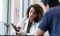 Female doctor uses tablet to show x-ray to senior man