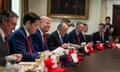 Donald Trump, third from left, with other members of his cabinet, all with Maga hats in front of them