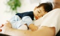 Baby asleep on father's chest