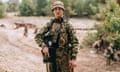 Luntik standing and looking at the camera with a gun in his hand