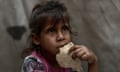 Palestinians receive hot meals from charities in Khan Yunis, Gaza, on 2 May 2025.