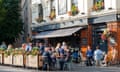 People drinking outside a pub.