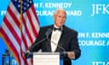 Man in tuxedo accepts award on stage