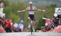 Tadej Pogacar celebrates at the finish line after winning the Flèche Wallonne