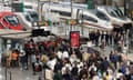 Passengers waiting near trains.