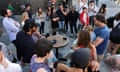A crowd of people gathered around a radio.